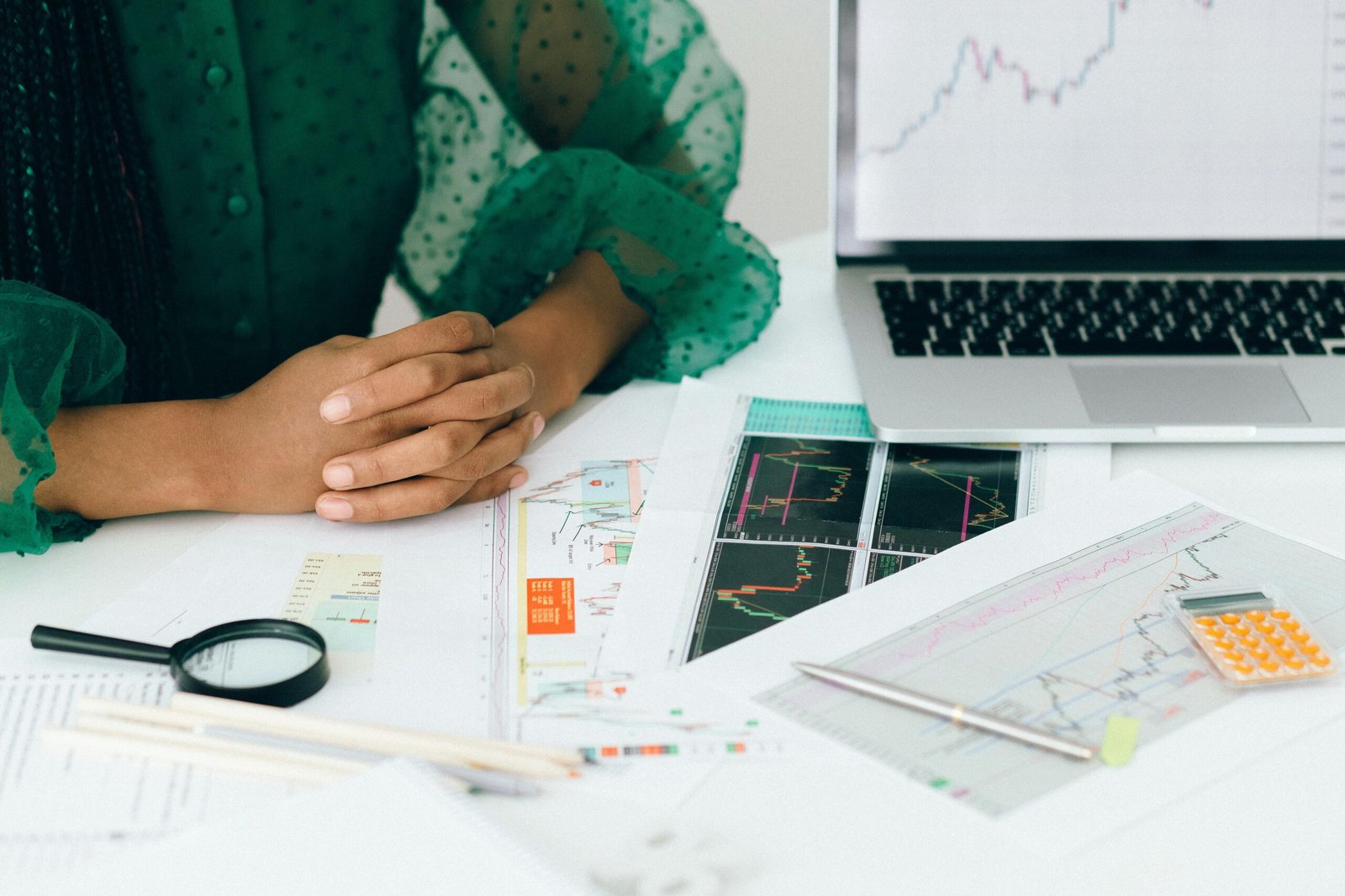 A person comparing different types of savings accounts with graphs showing interest rate trends.