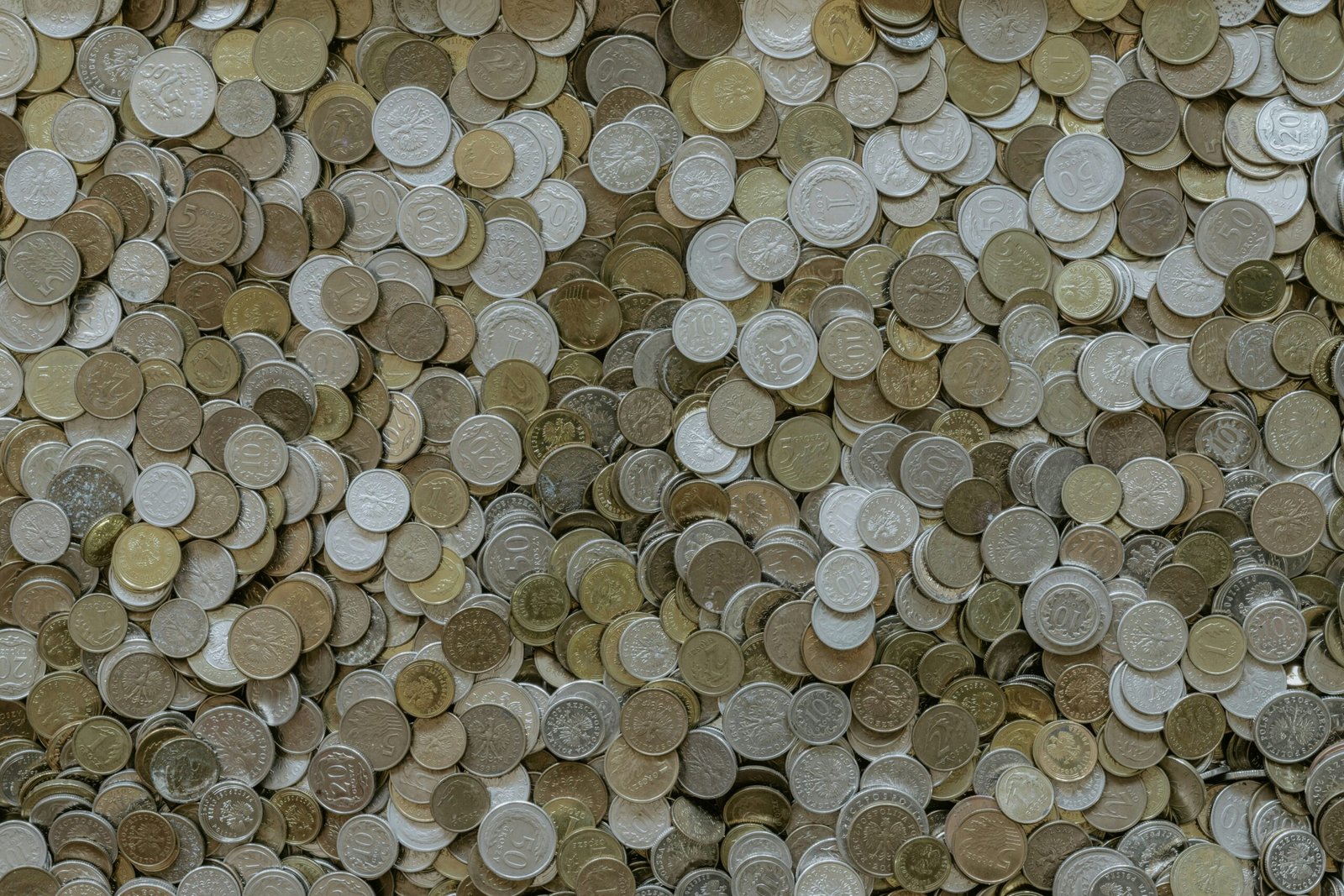 Photo of a smiling teenager holding a piggy bank full of coins