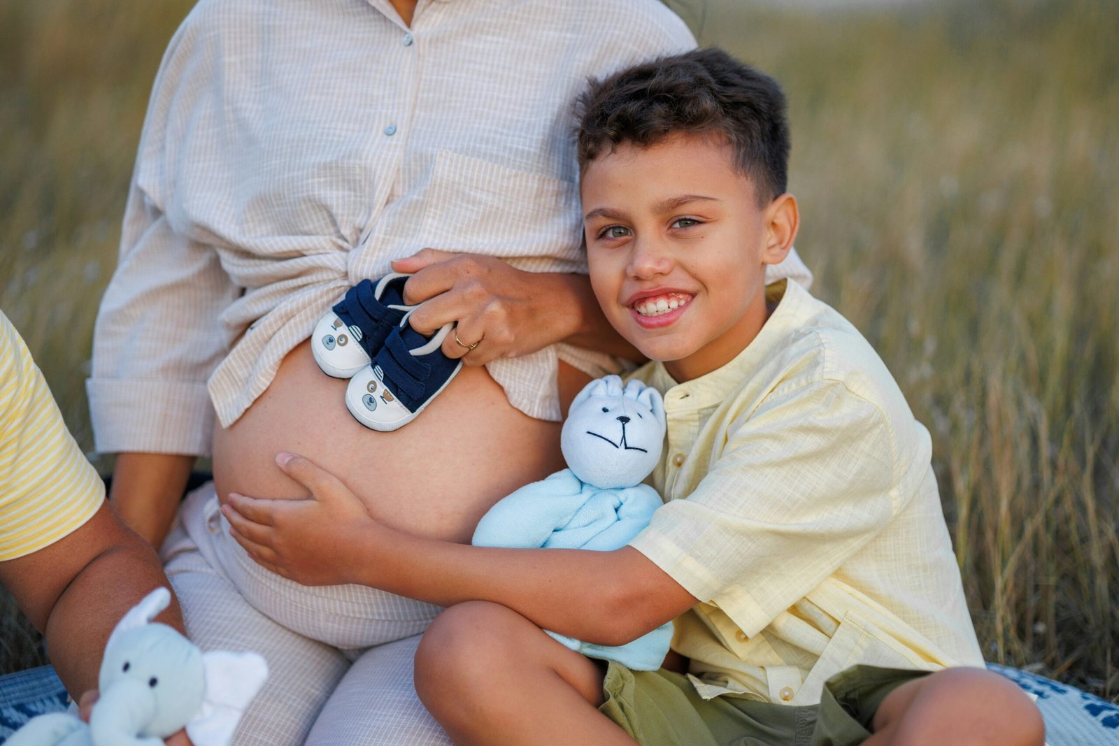 Photo of Sarah celebrating with her son as they review his savings progress chart