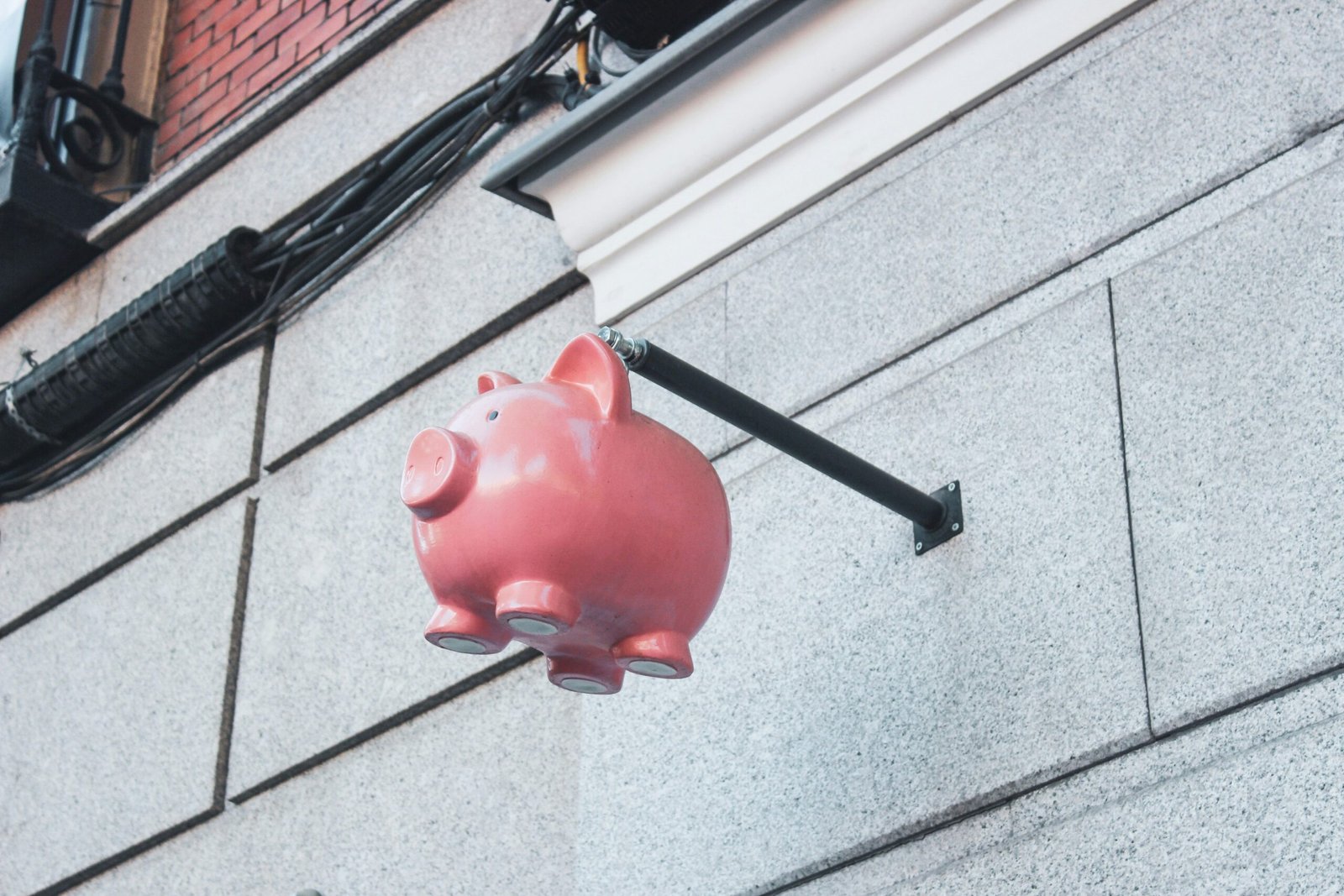 Teenager celebrating reaching a savings goal with piggy bank