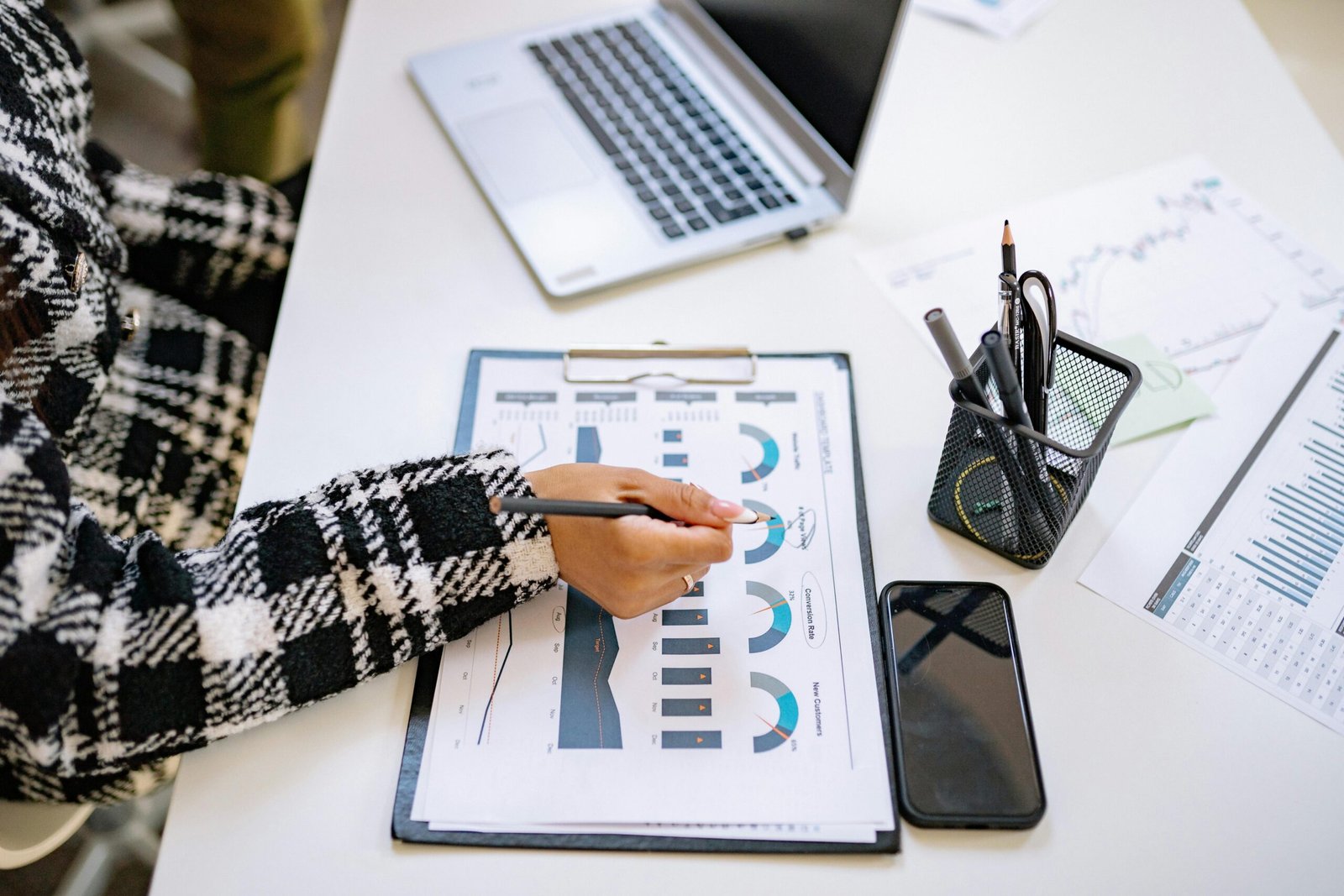 Two people reviewing investment charts together, highlighting success stories of smart interest rate planning.
