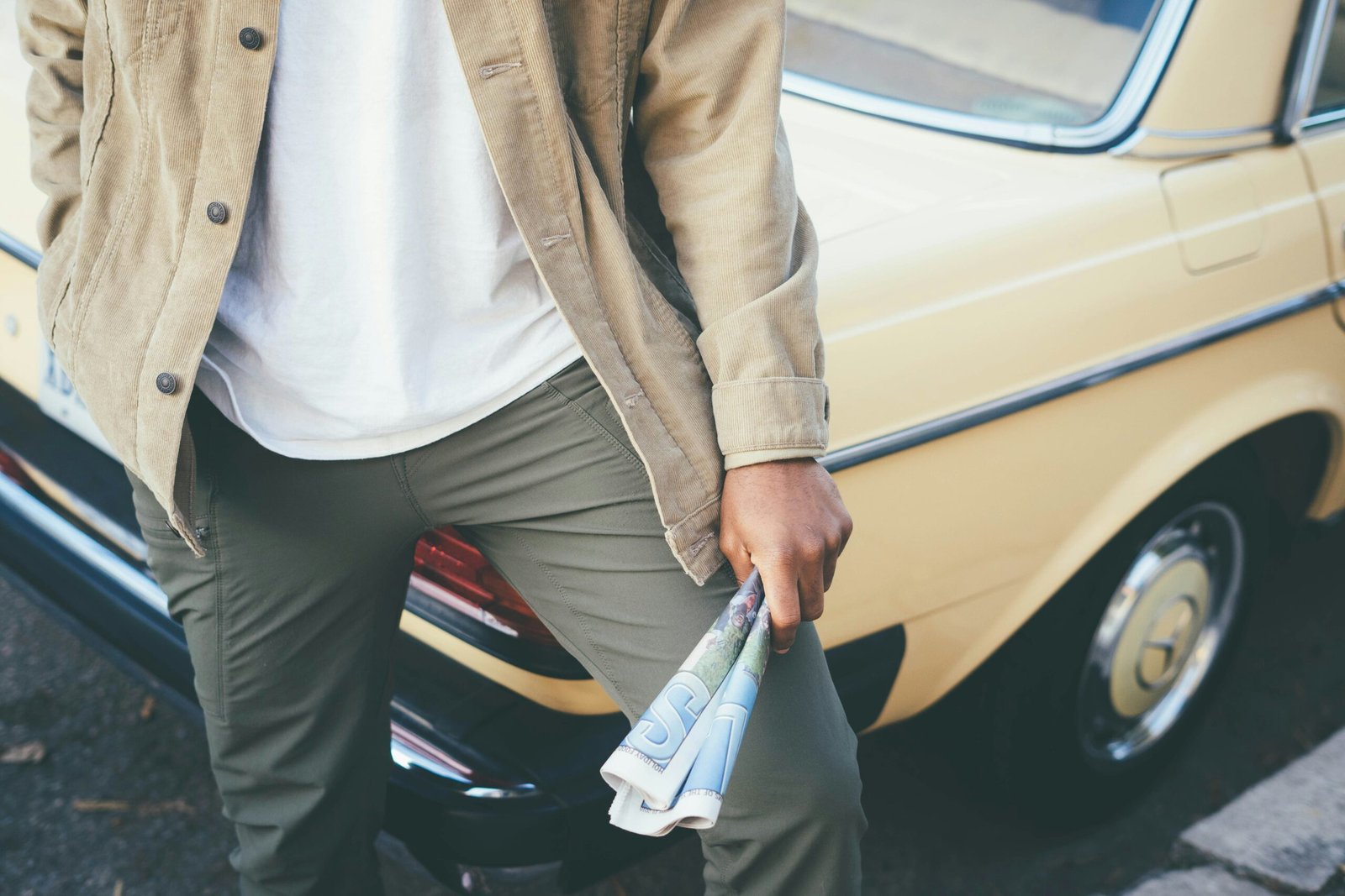 A young person smiling while checking their savings account balance on their phone